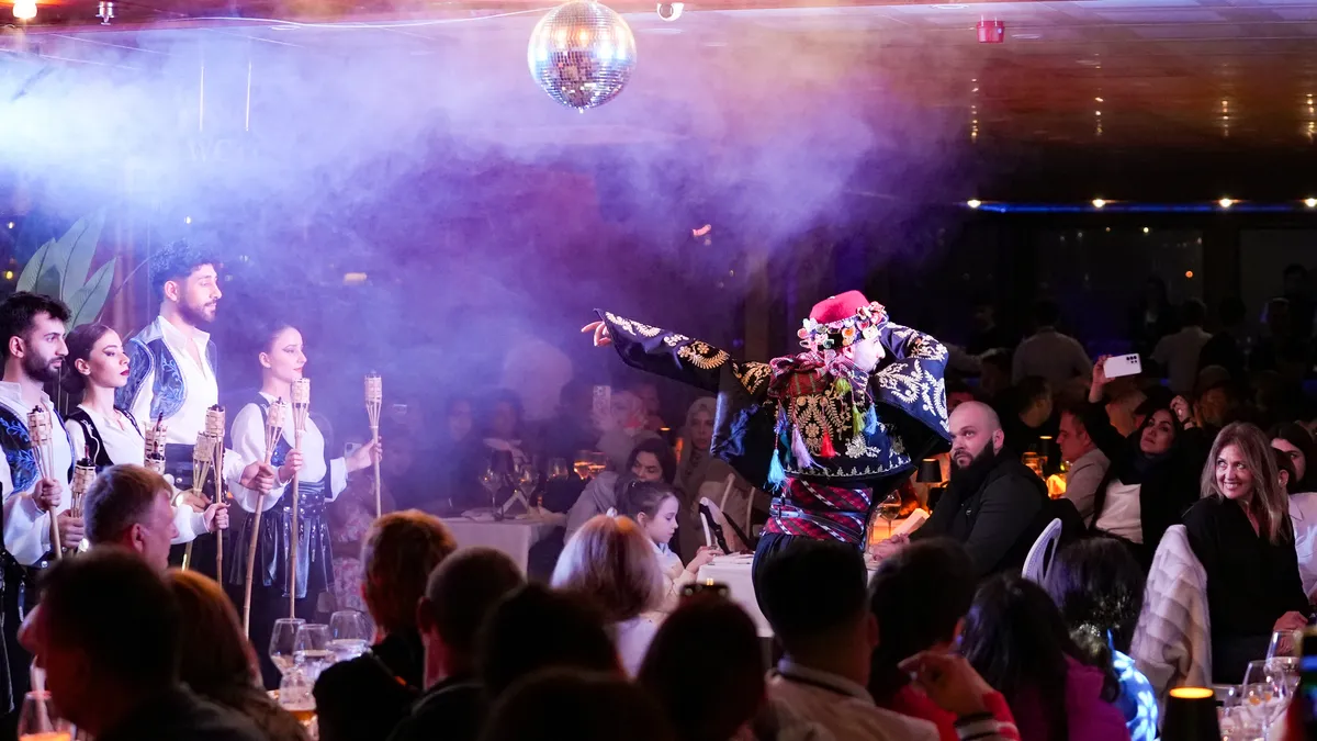 Caucasian dancer whirling in stage smoke under the mirror ball on board