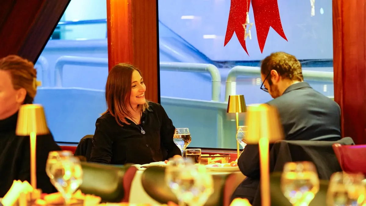 Couple enjoying dinner at a window table with the Bosphorus behind on the AMOR