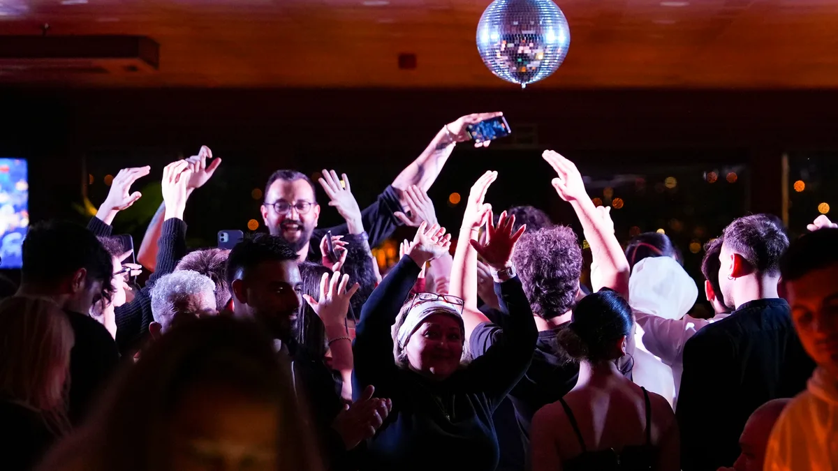 Guests on the dance floor aboard the AMOR