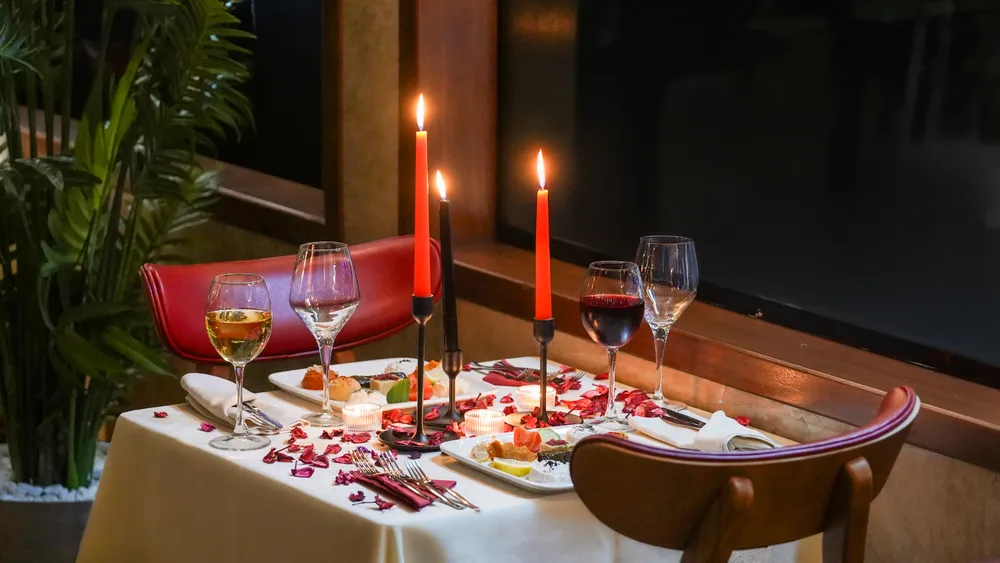 A table decorated with candles and rose petals on the Bosphorus Night dinner cruise