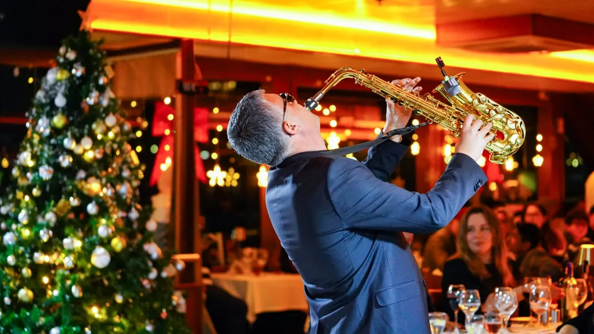 Saxophonist performing live during the after-party on the AMOR dinner cruise
