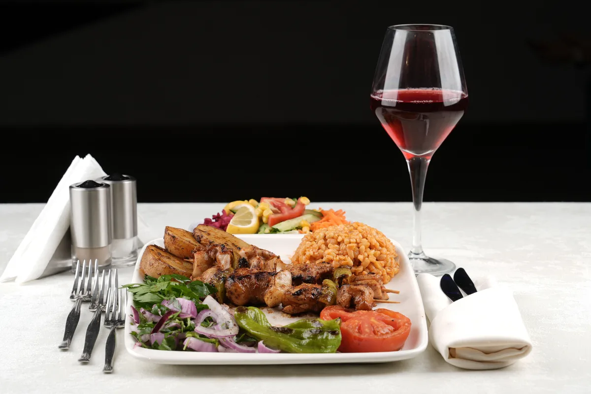 Main course served with wine on the AMOR dinner cruise