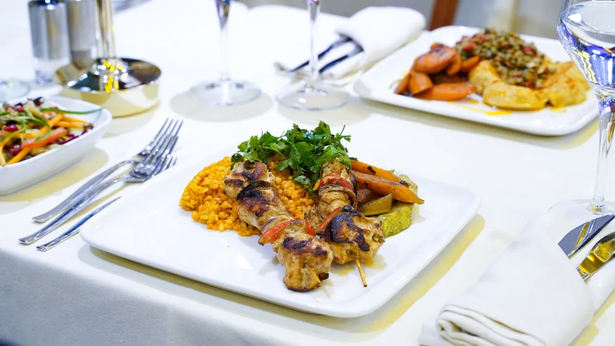 Chicken skewer with bulgur pilaf and roasted vegetables on the AMOR dinner cruise