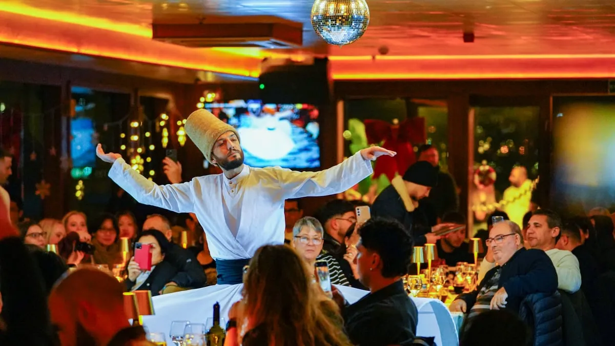 Whirling dervish performing the Mevlevi Sema among the guest tables on the AMOR