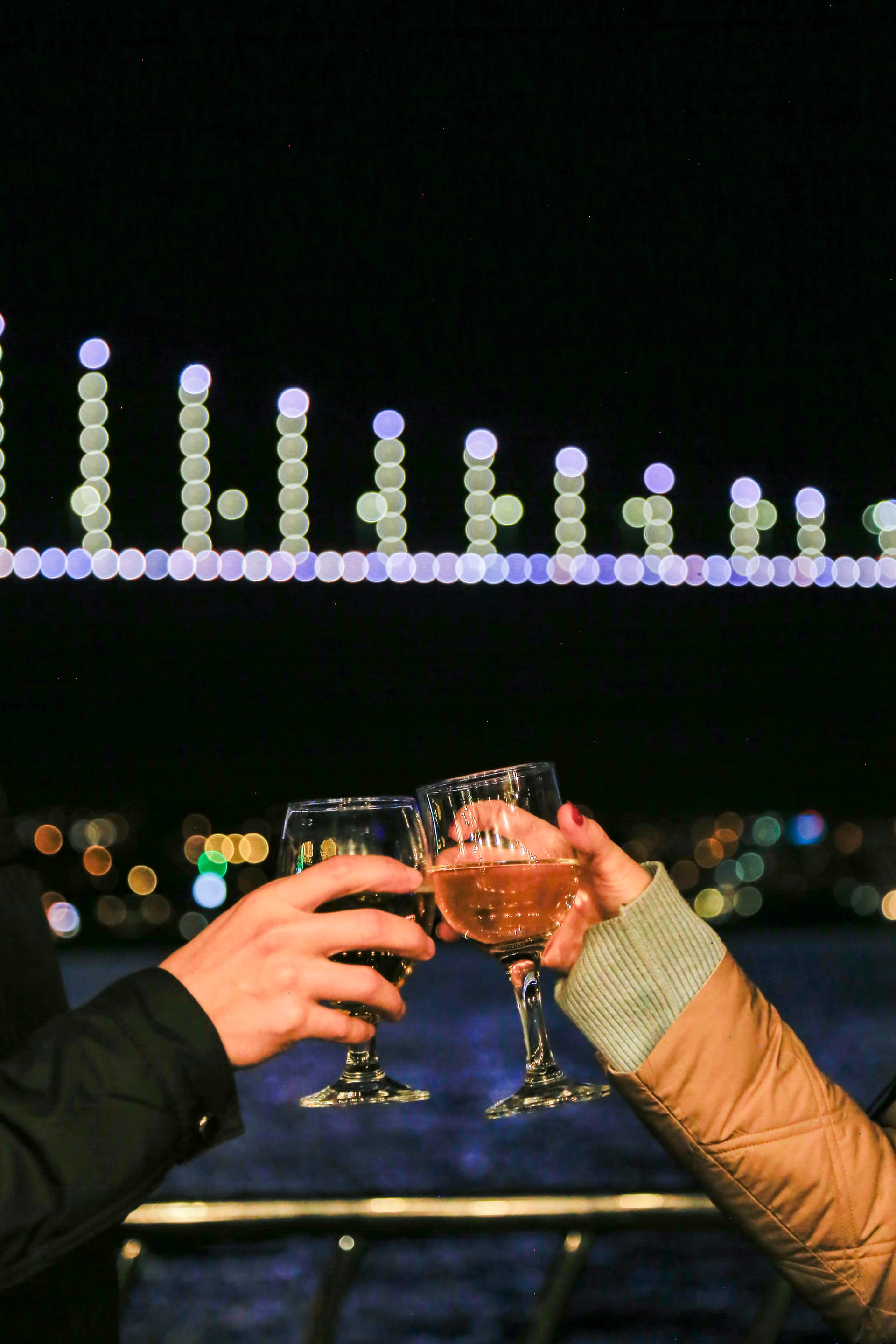 Couple Cheers with Bridge Lights